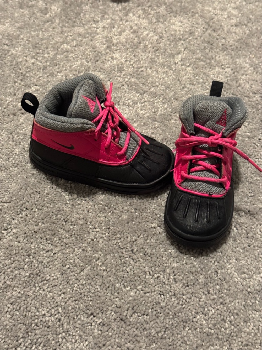 pink and black Nike Woodside 2 High ACG toddler winter boots